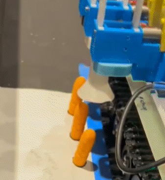 The compliant gripper picking up game pieces in competition